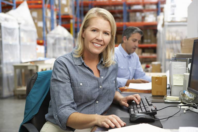 businesswoman working at desk in warehouse
