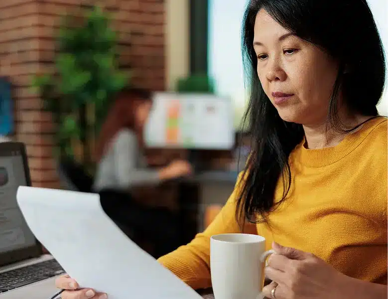 successful female with tea cup and page